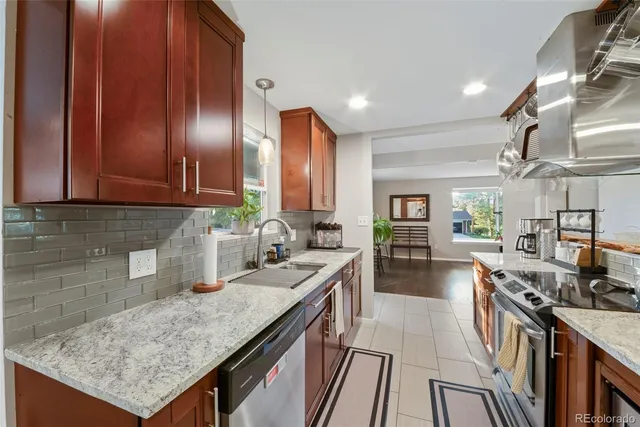 a kitchen with granite countertop lots of counter top space and stainless steel appliances