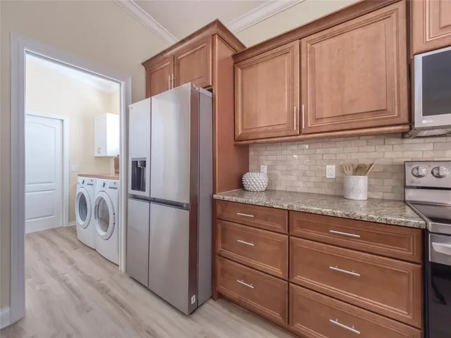 a bathroom with a granite countertop sink and a large mirror