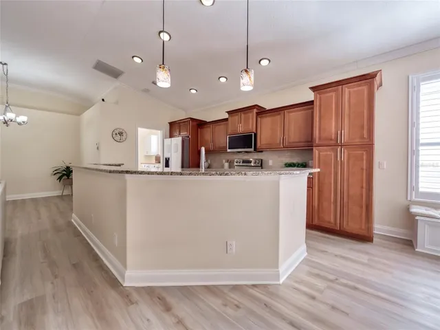 a view of a hallway to a livingroom with wooden floor
