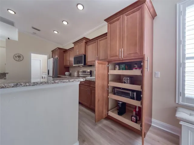 a living room with furniture a chandelier and a window