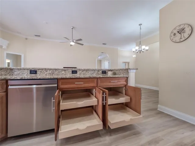 a living room with patio furniture and a floor to ceiling window