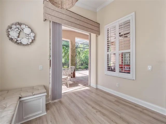 a living room with furniture a chandelier and a rug