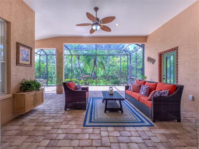 an empty room with wooden floor cabinet and windows