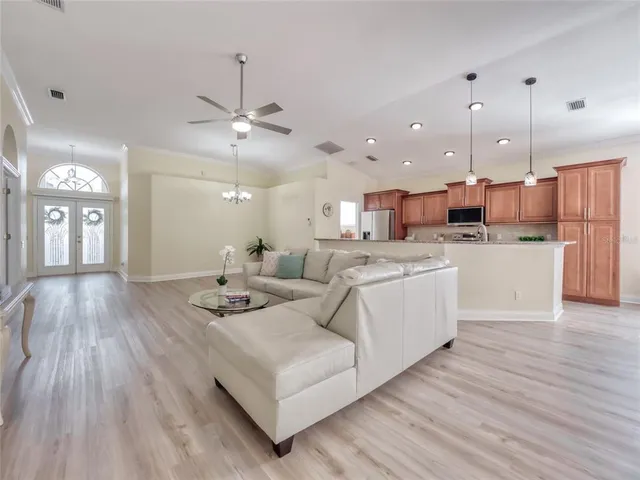 a living room with furniture and wooden floor