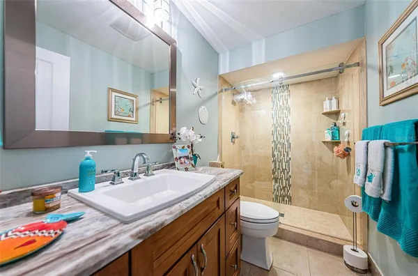 a bathroom with a sink toilet tub and shower