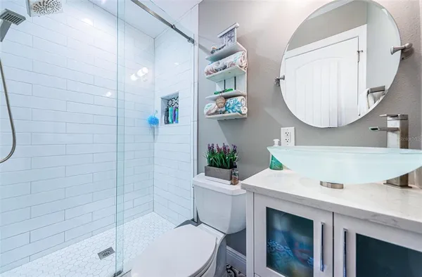 a bathroom with a sink toilet and shower