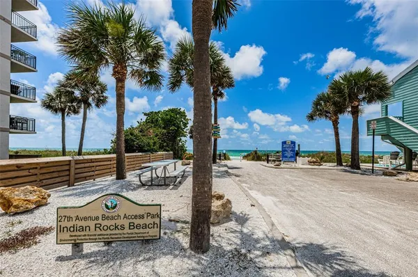 a view of a street with palm trees