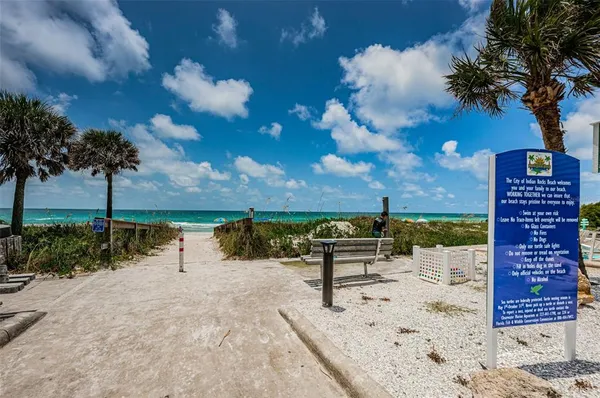 a view of a terrace with lawn chairs
