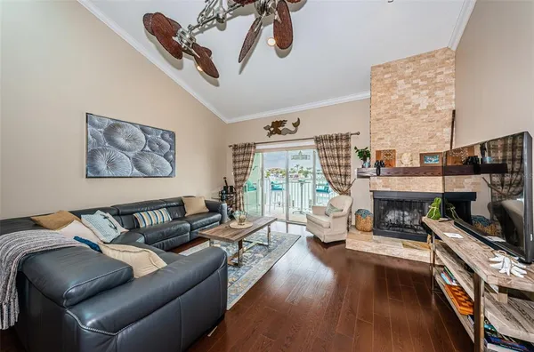 a living room with furniture a fireplace and a floor to ceiling window
