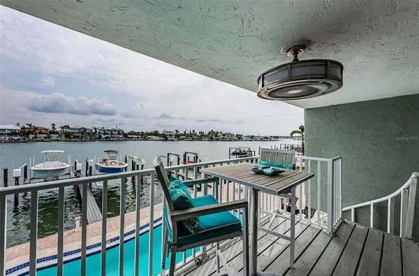 a view of a balcony chairs and wooden floor