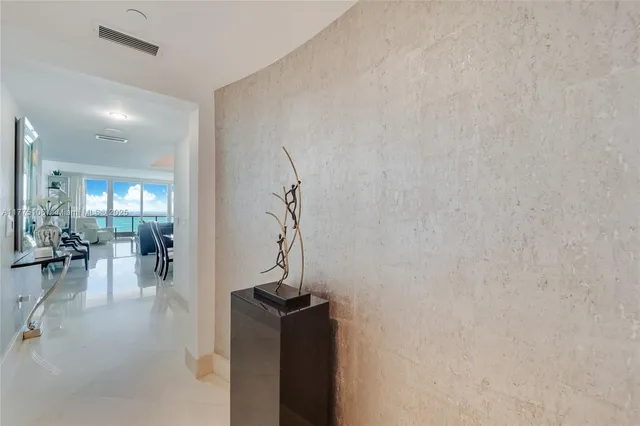 a spacious bedroom with a bed a couch and large window