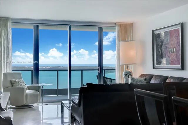 a living room with furniture and a floor to ceiling window