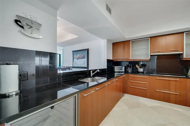 a kitchen with stainless steel appliances granite countertop a refrigerator and a sink