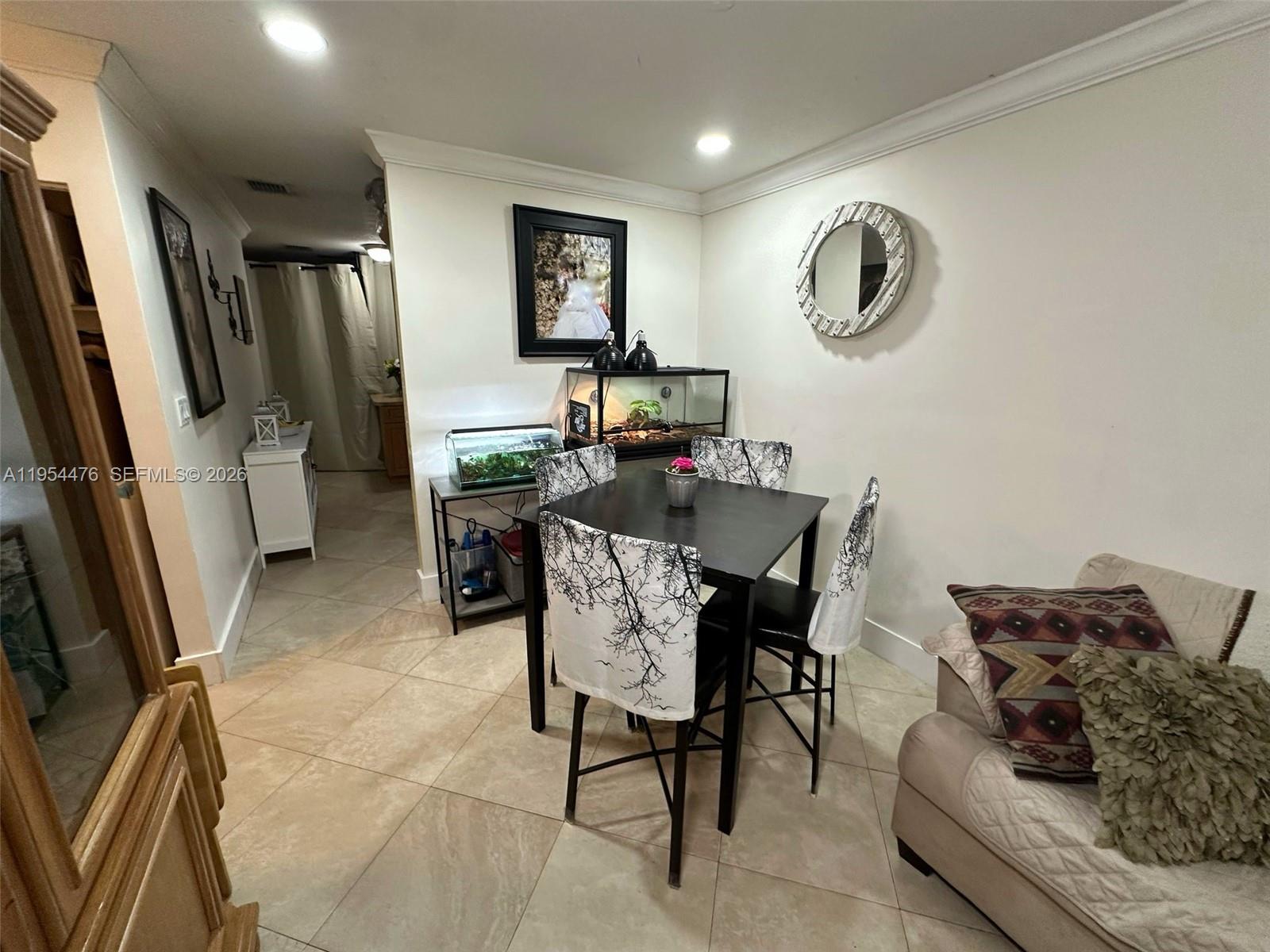 11537 Southwest 6th Street Sweetwater, FL 33174 - Photo 2 of 7 a workspace with furniture and a large window