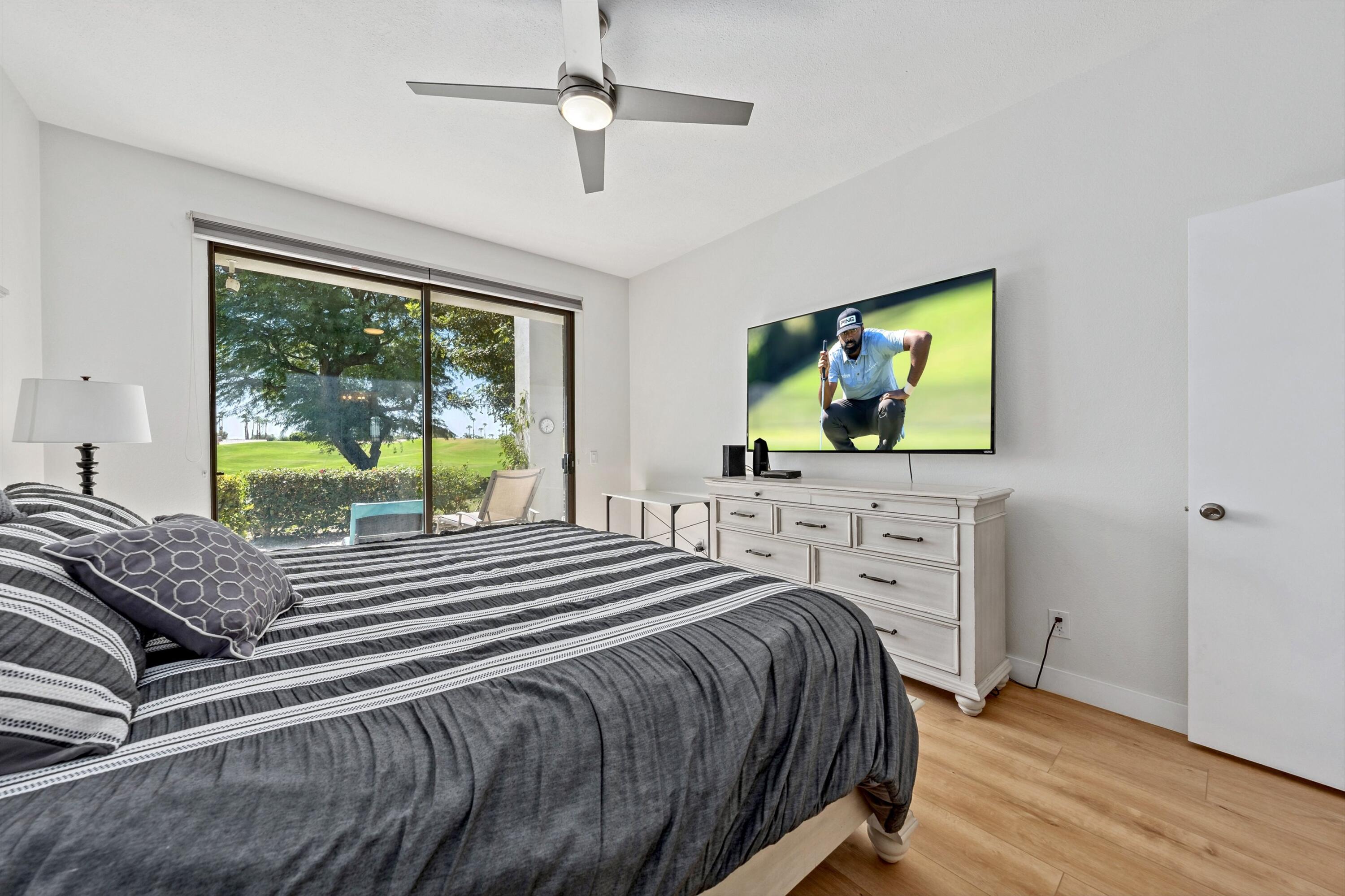 54326 Oak-Tree, Unit A122 La Quinta, CA 92253 - Photo 11 of 32 a bedroom with a bed and a flat screen tv