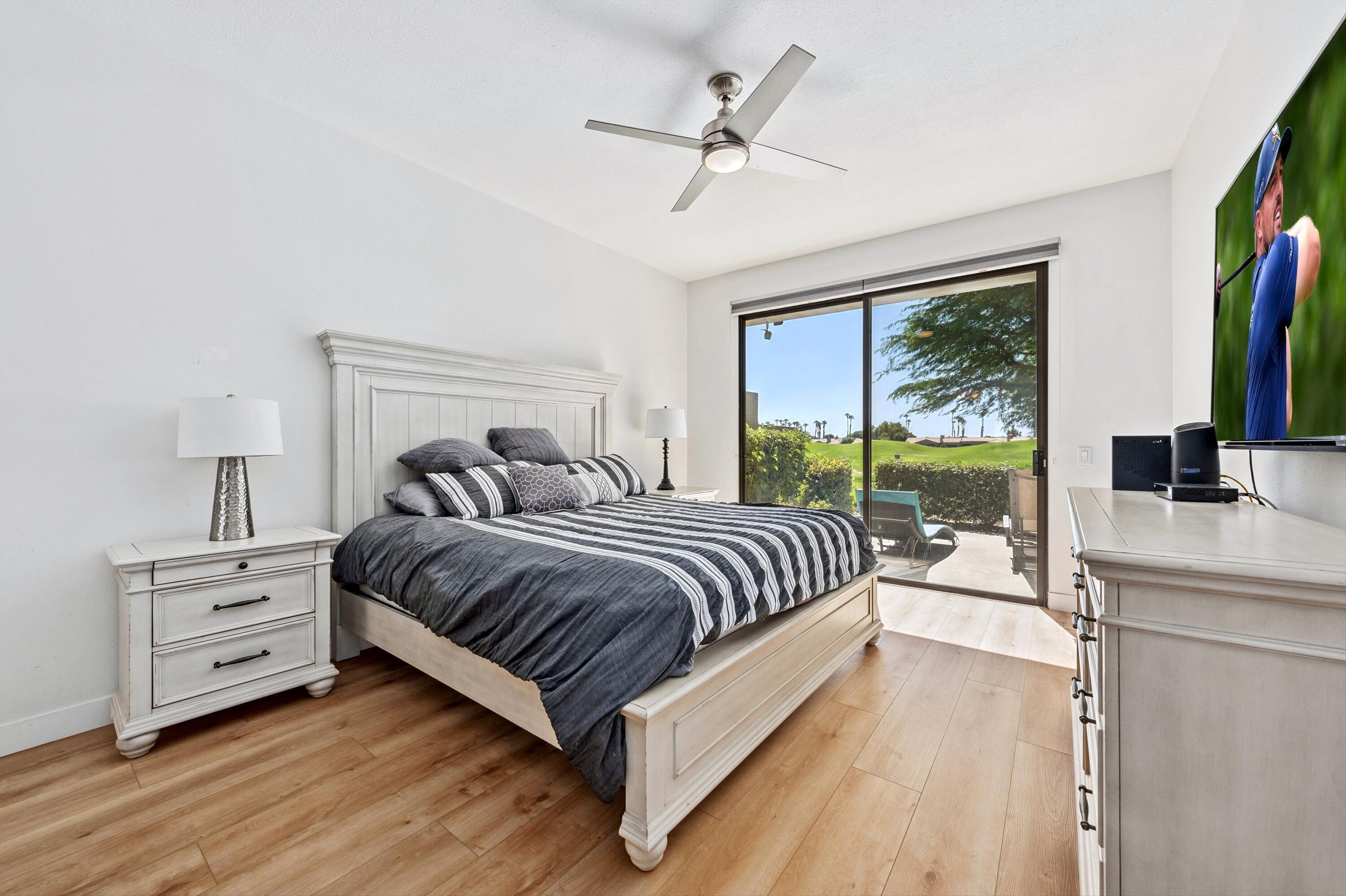 54326 Oak-Tree, Unit A122 La Quinta, CA 92253 - Photo 12 of 32 a spacious bedroom with a large bed and a flat tv screen