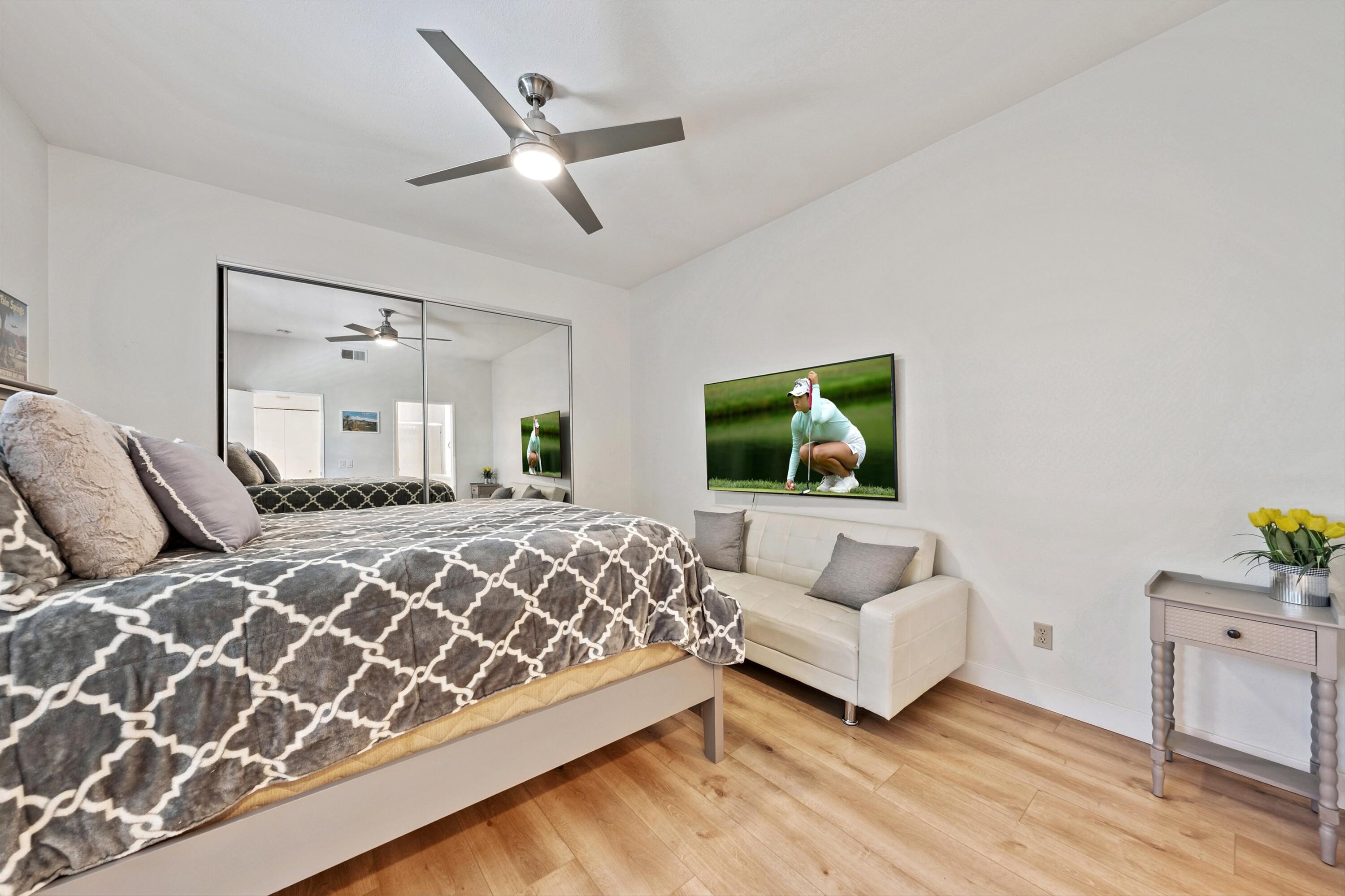 54326 Oak-Tree, Unit A122 La Quinta, CA 92253 - Photo 15 of 32 a bedroom with a large bed and a couch