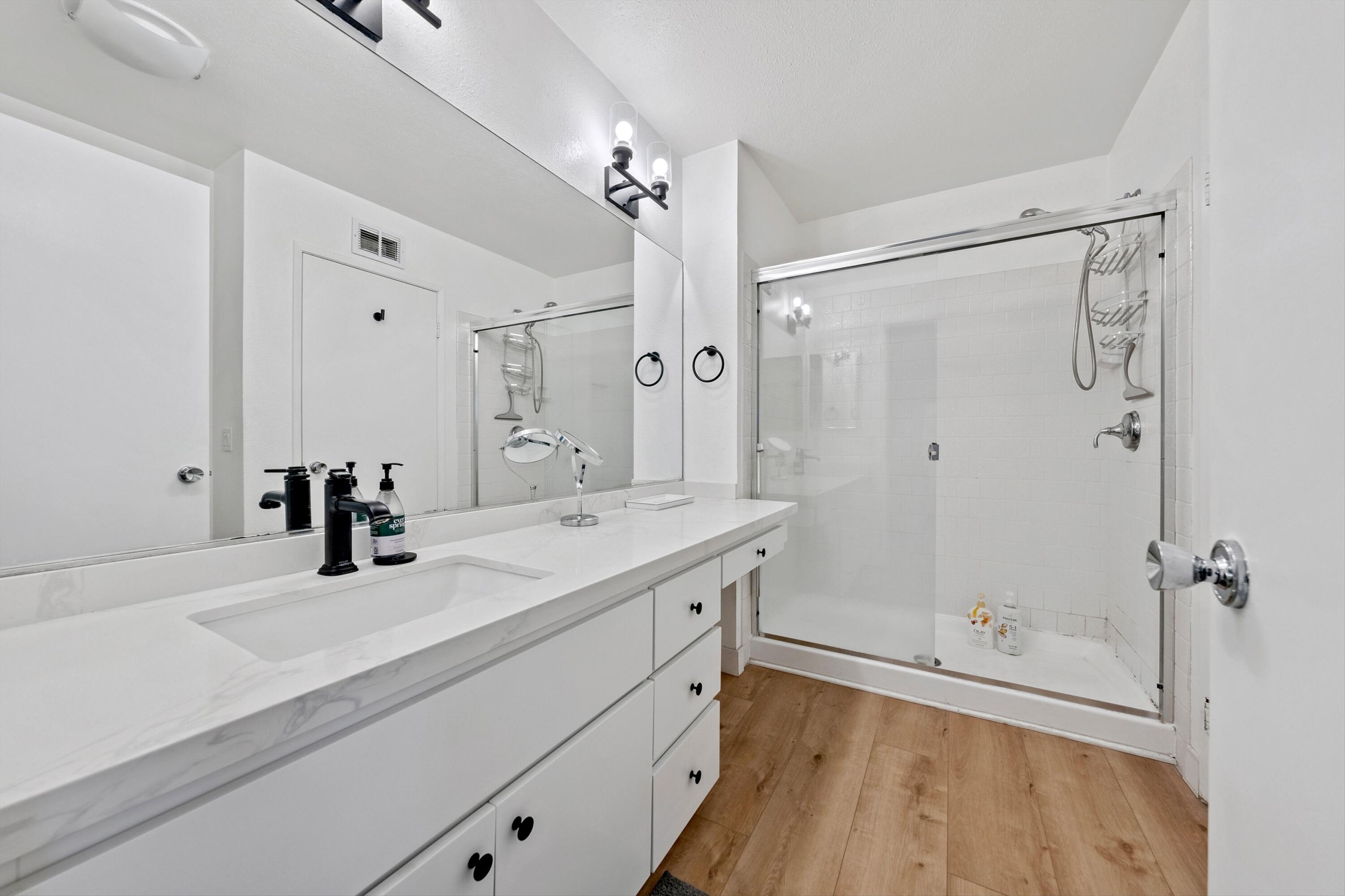 54326 Oak-Tree, Unit A122 La Quinta, CA 92253 - Photo 16 of 32 a bathroom with a double vanity sink a mirror and shower