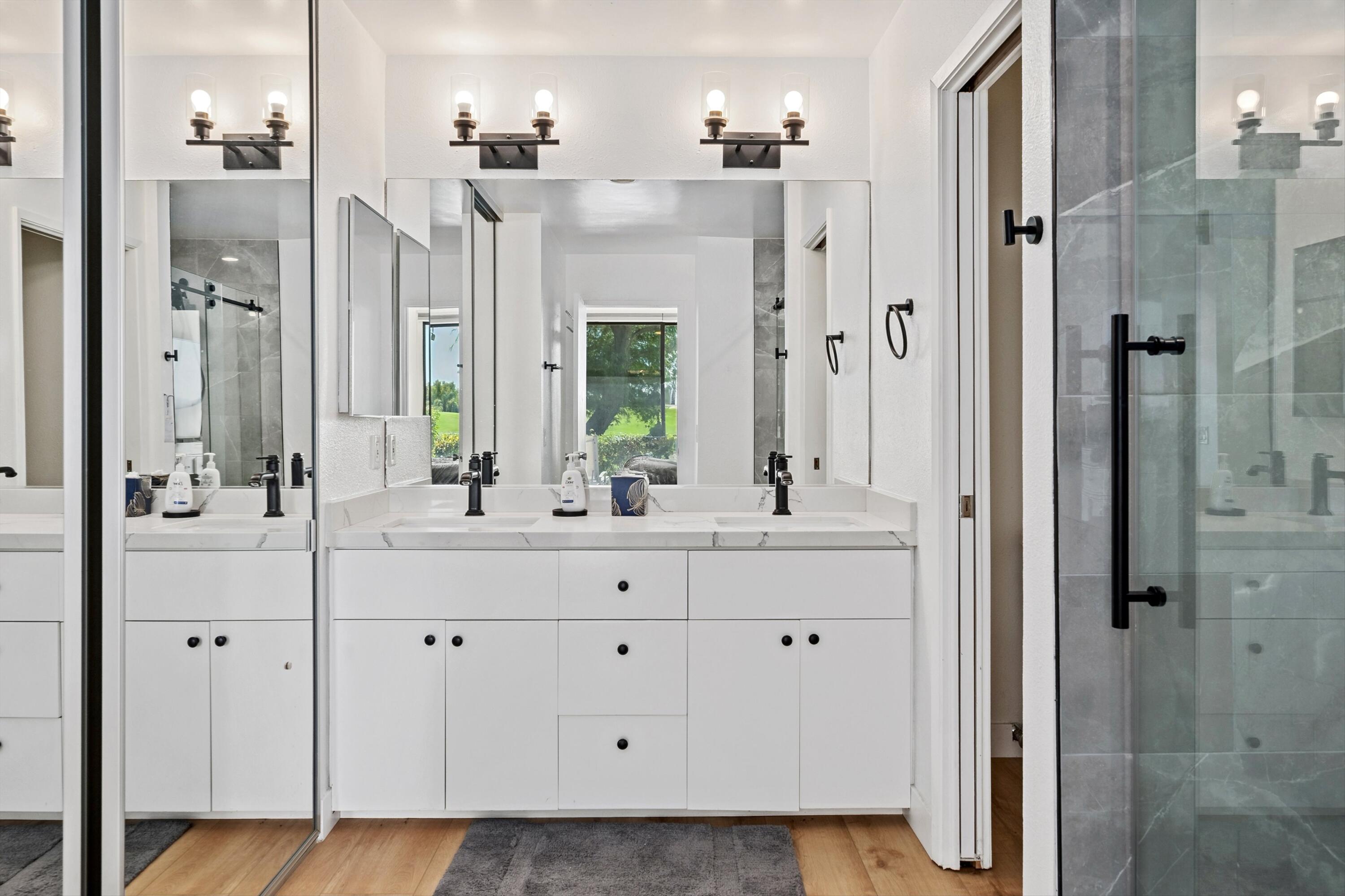 54326 Oak-Tree, Unit A122 La Quinta, CA 92253 - Photo 17 of 32 a bathroom with a shower sink and mirror