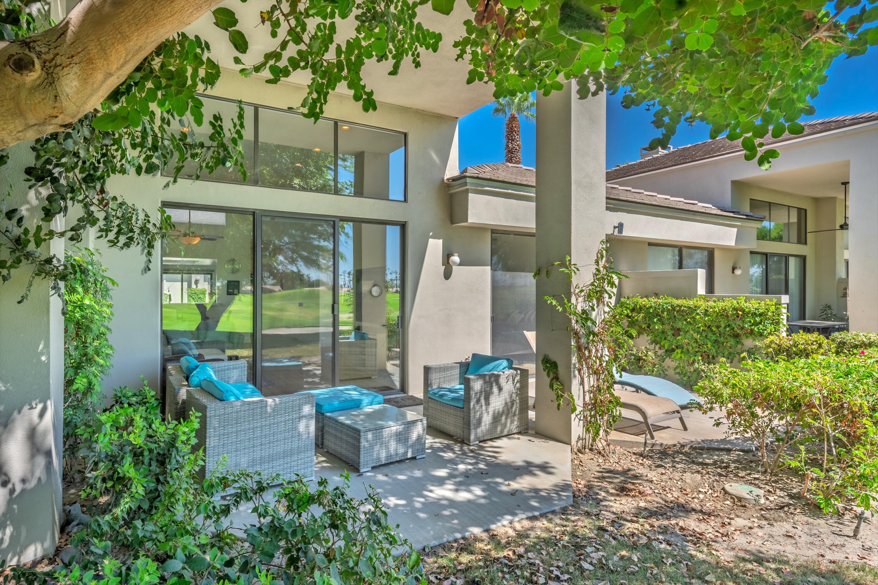 54326 Oak-Tree, Unit A122 La Quinta, CA 92253 - Photo 31 of 32 a view of a patio with table and chairs and potted plants