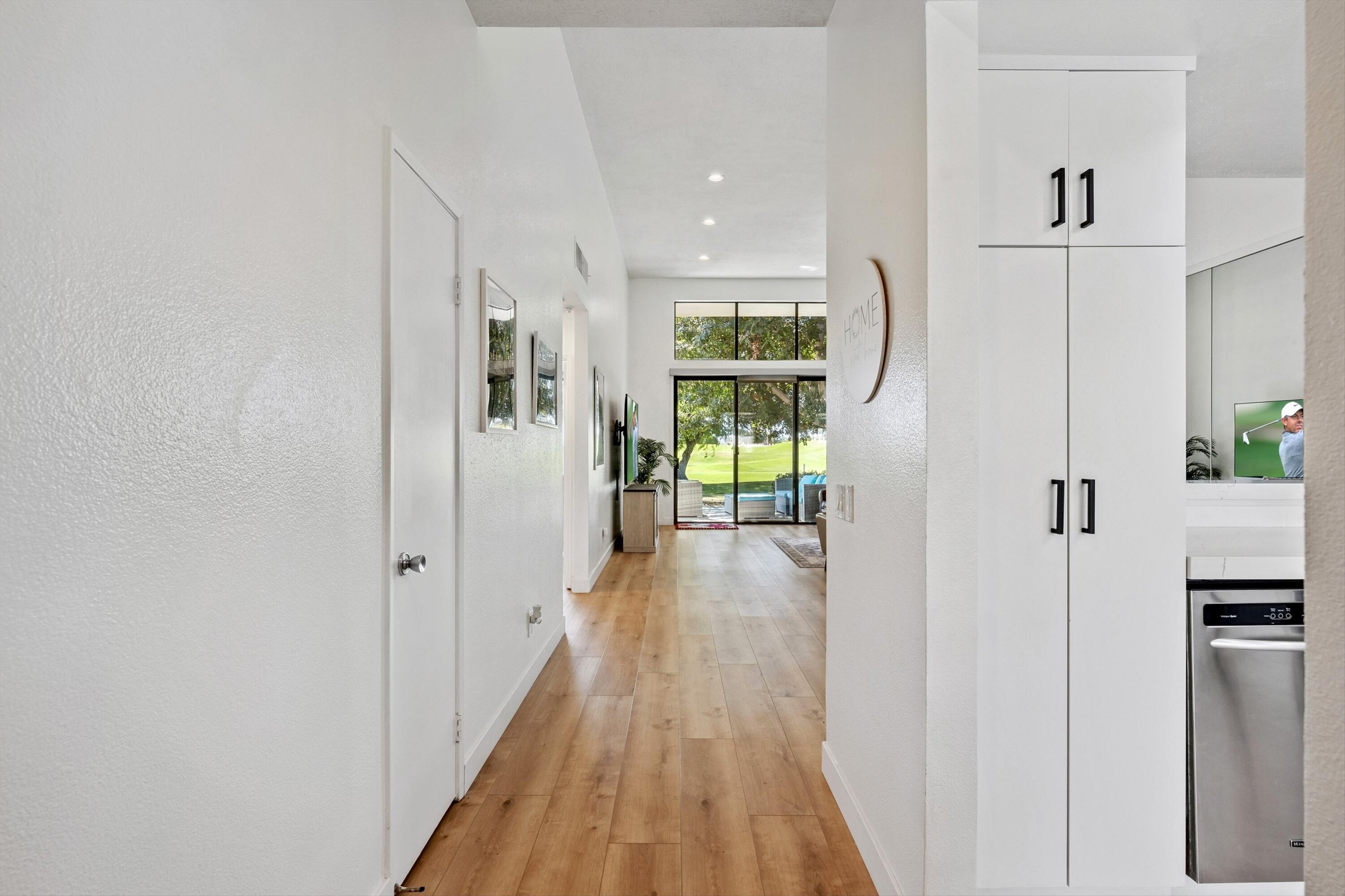 54326 Oak-Tree, Unit A122 La Quinta, CA 92253 - Photo 5 of 32 a view of a hallway with wooden floor and a refrigerator