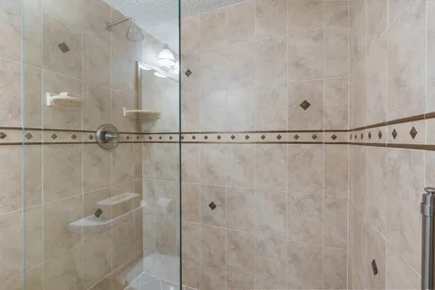 a bathroom with a shower and a mirror