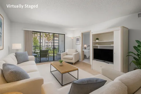 a living room with furniture ceiling fan and a flat screen tv