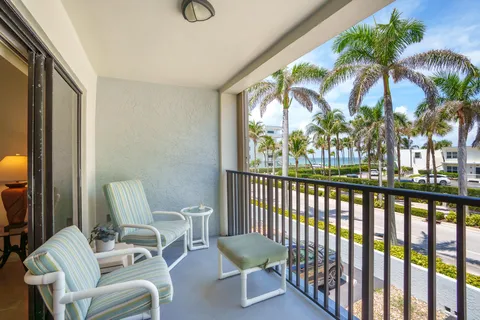 a view of a chair and tables in the balcony