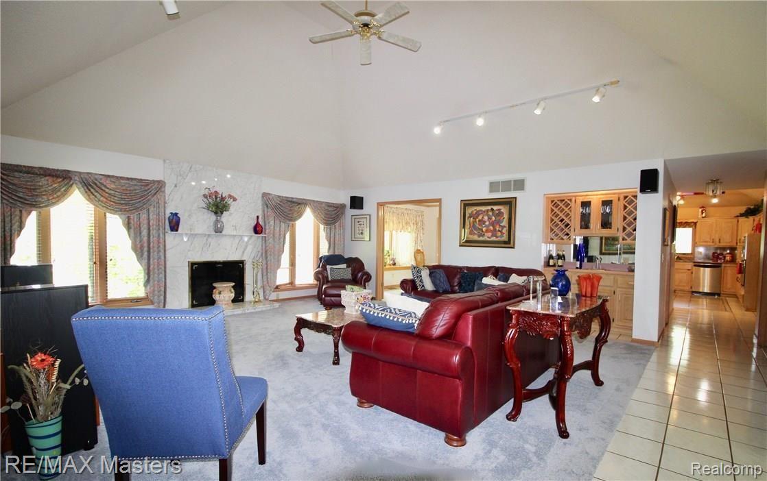 As you walk in to this spacious great room, you can enjoy the size of the room, the vaulted ceiling, extra lighting feature, and the wet bar...it's a perfect spot for entertaining! The gas fireplace is marble faced and everything's neutral for you to bring your finishing touches!