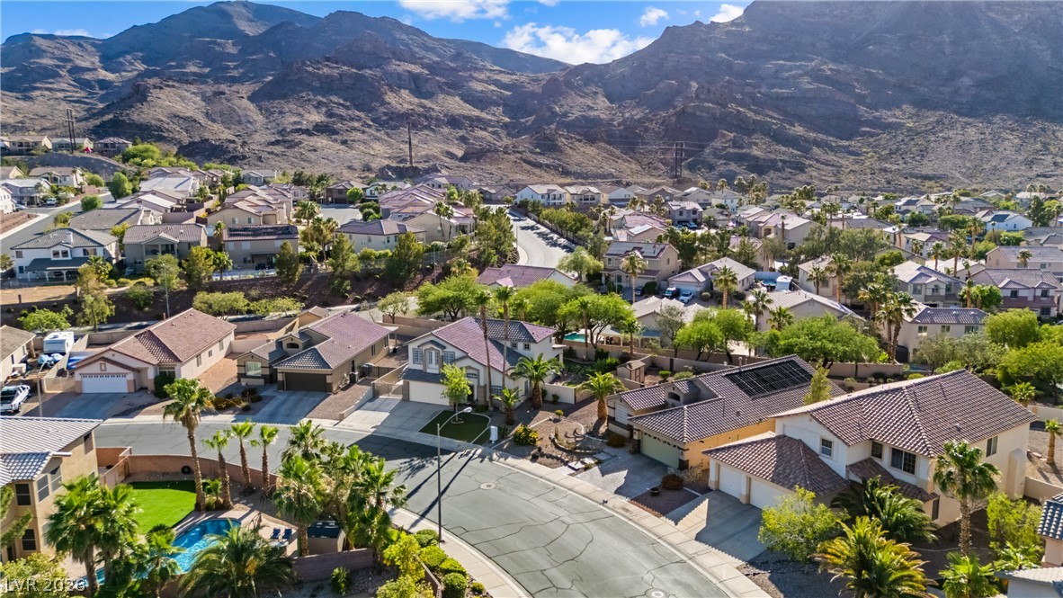 708 Vortex Avenue Henderson, NV 89002 - Photo 56 of 71 An aerial panorama reveals a residential enclave nestled against majestic mountains, showcasing community views and individual home features.