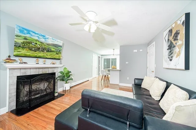 a living room with furniture a fireplace and a flat screen tv