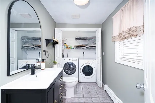 a bathroom with a sink a toilet and a mirror