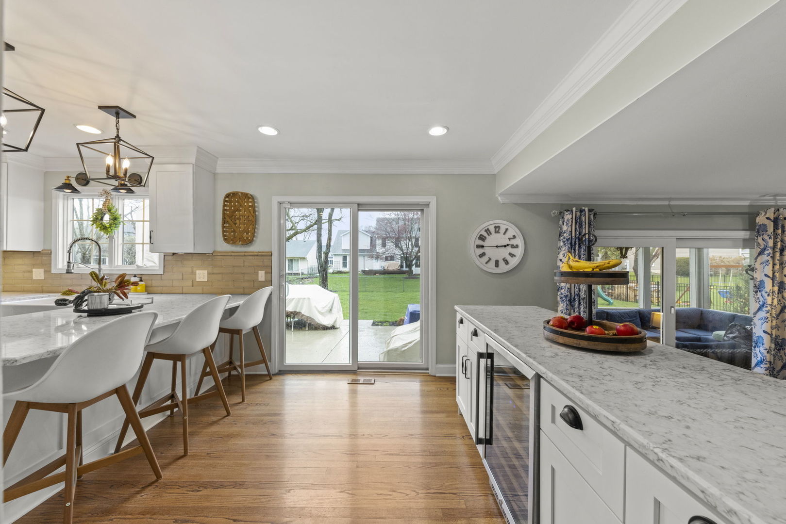 1908 Gladstone Drive Wheaton, IL 60189 - Photo 11 of 53 a kitchen with stainless steel appliances granite countertop a refrigerator a sink dishwasher a dining table and chairs with wooden floor