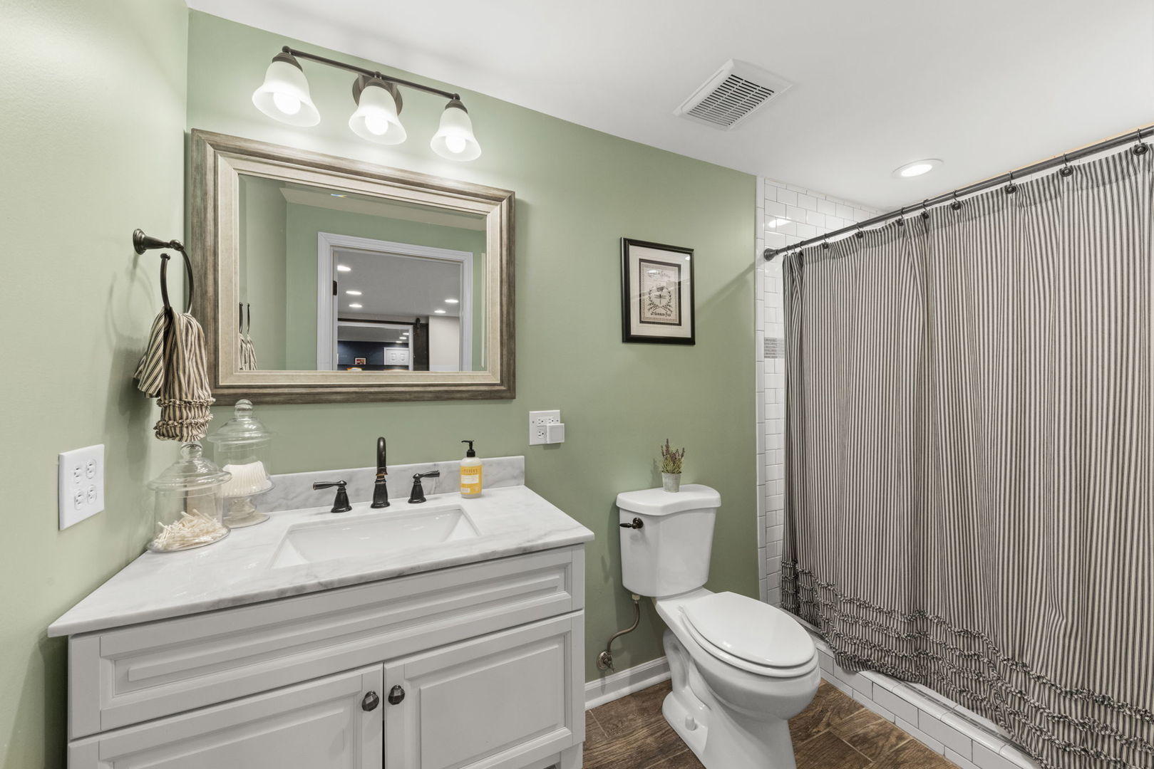 1908 Gladstone Drive Wheaton, IL 60189 - Photo 33 of 53 a bathroom with a toilet a sink and mirror