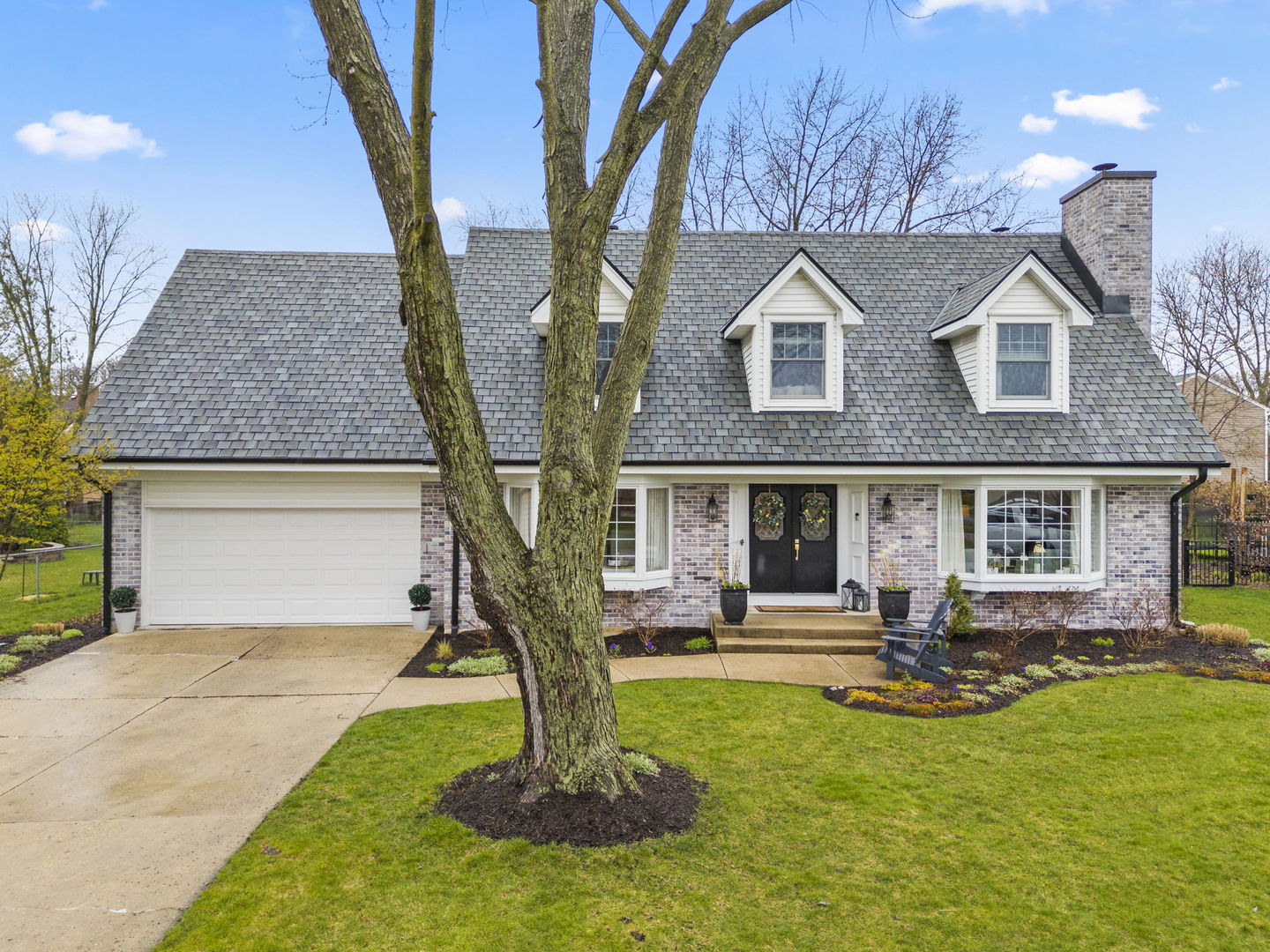 1908 Gladstone Drive Wheaton, IL 60189 - Photo 41 of 53 a front view of a house with garden