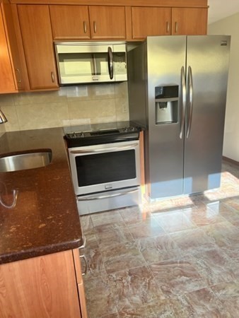 30-32 Joseph Street Springfield, MA 01119 - Photo 4 of 20 a kitchen with granite countertop a stove and a refrigerator