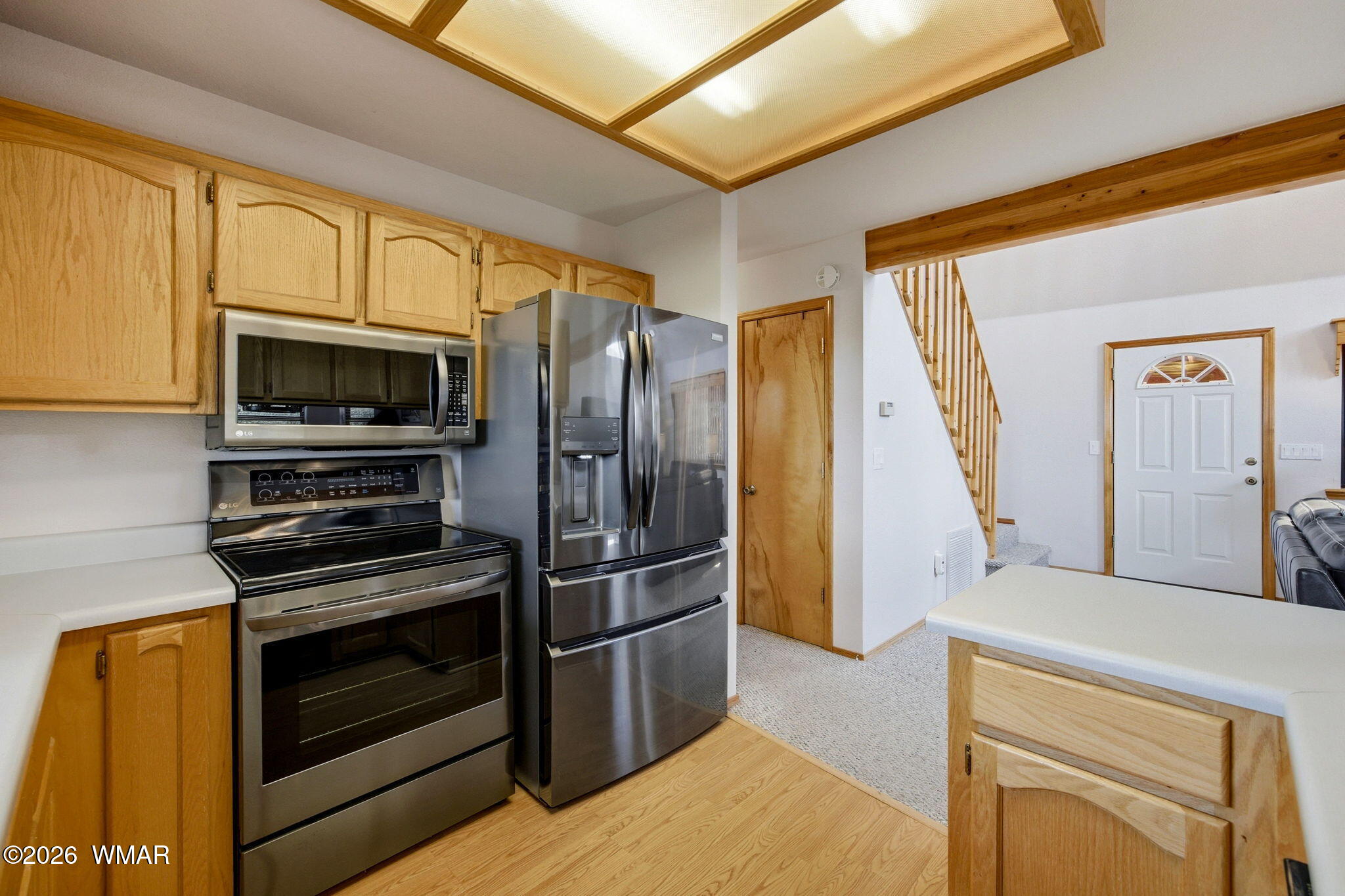 2806 Sky Hawk Drive Overgaard, AZ 85933 - Photo 17 of 43 a kitchen with stainless steel appliances a stove refrigerator and microwave