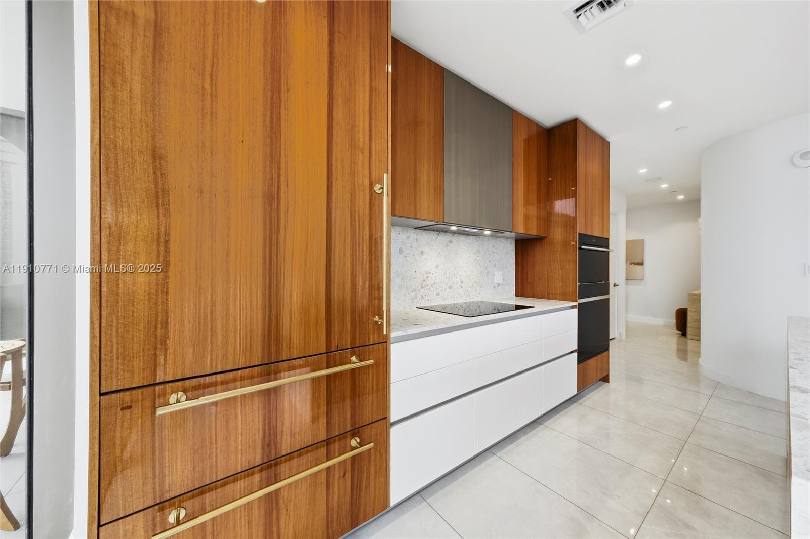 2678 Tigertail Avenue, Unit 1110 Miami, FL 33133 - Photo 11 of 77 a kitchen with stainless steel appliances a refrigerator and cabinets
