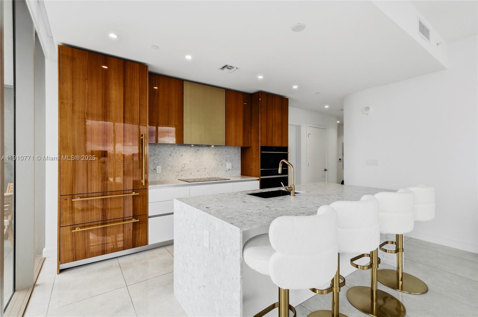 2678 Tigertail Avenue, Unit 1110 Miami, FL 33133 - Photo 12 of 77 a kitchen with stainless steel appliances granite countertop a refrigerator and a sink