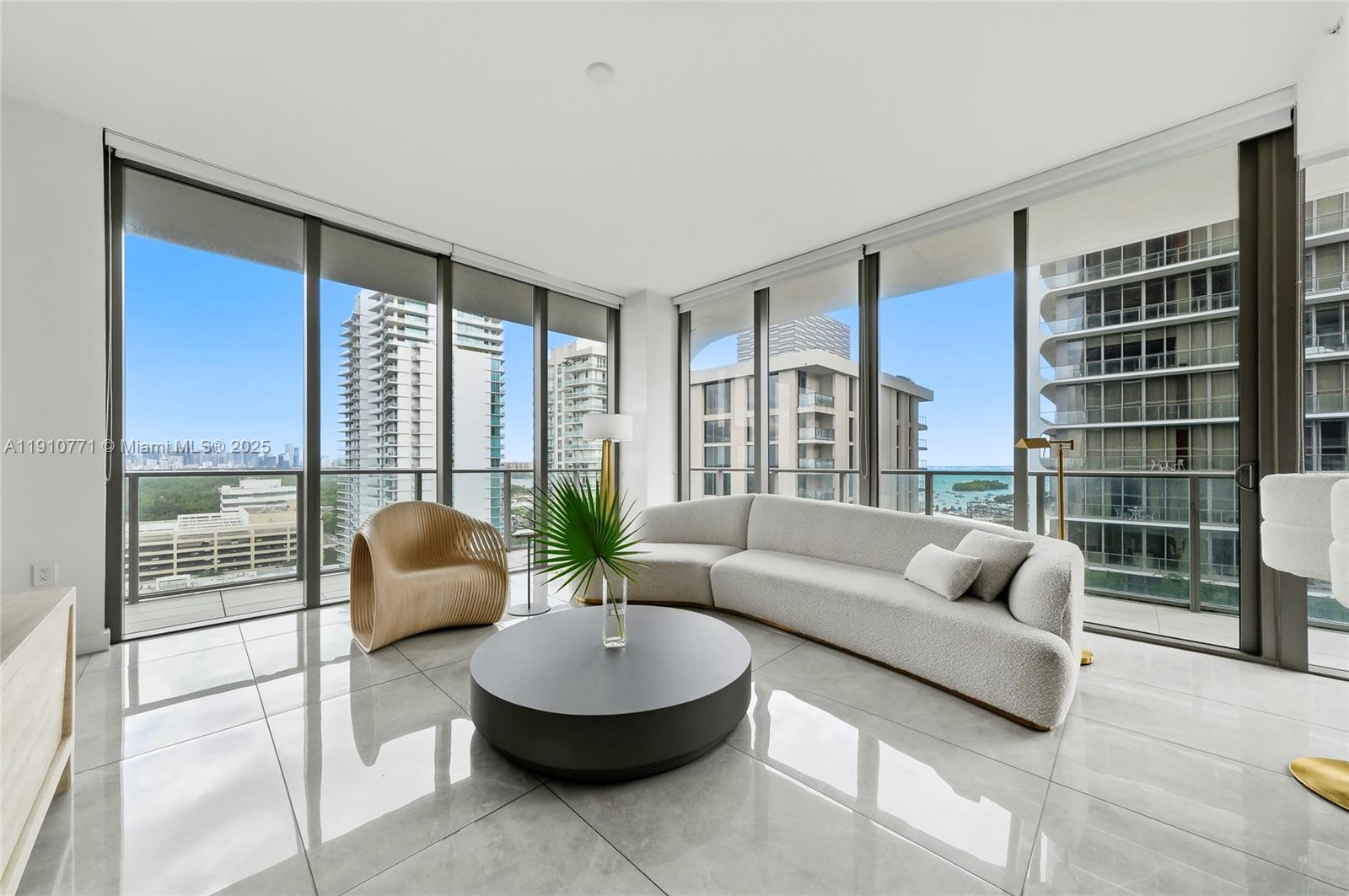 2678 Tigertail Avenue, Unit 1110 Miami, FL 33133 - Photo 14 of 77 a living room with furniture and a large window