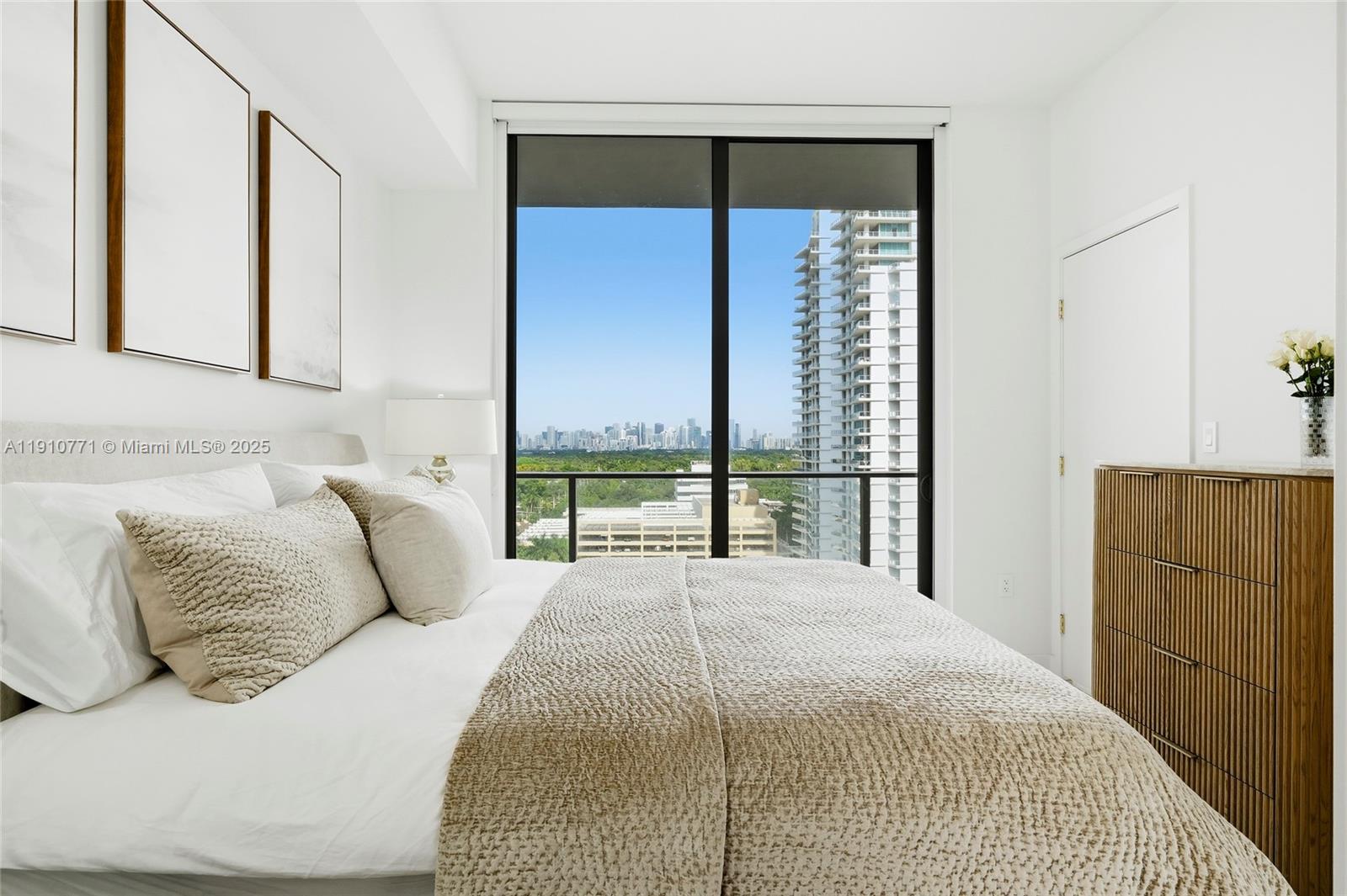 2678 Tigertail Avenue, Unit 1110 Miami, FL 33133 - Photo 17 of 77 a bedroom with a large bed and a large window