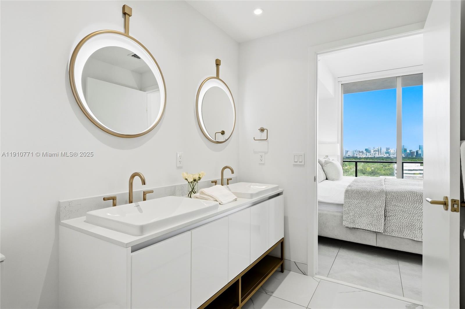 2678 Tigertail Avenue, Unit 1110 Miami, FL 33133 - Photo 18 of 77 a en suite bathroom with a double vanity sink and a mirror