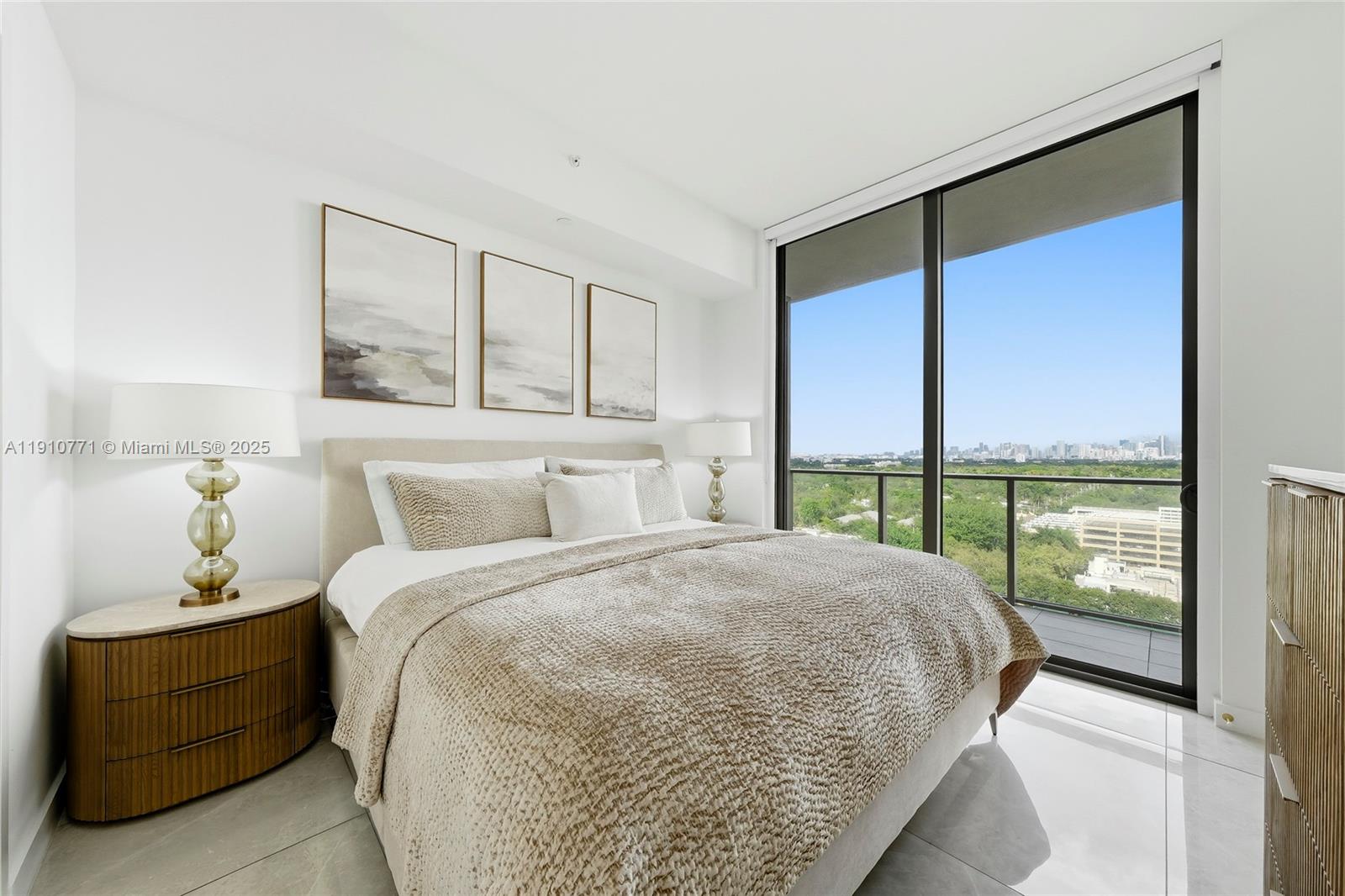 2678 Tigertail Avenue, Unit 1110 Miami, FL 33133 - Photo 23 of 77 a bed sitting in a bedroom next to a window