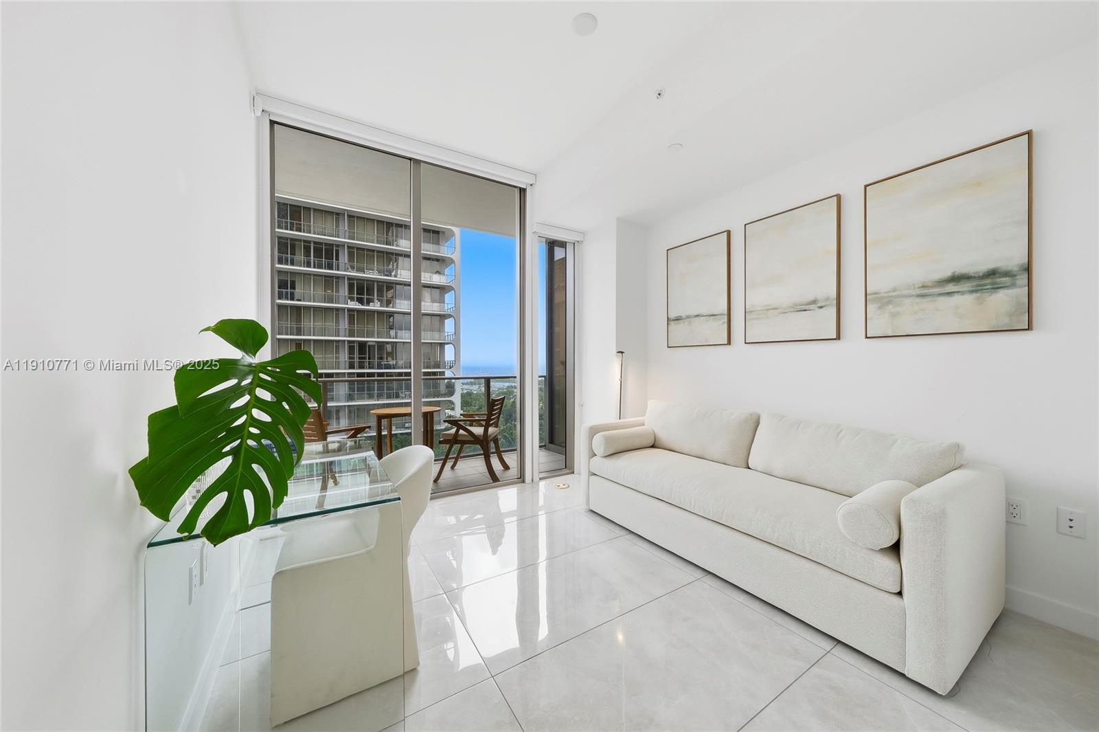2678 Tigertail Avenue, Unit 1110 Miami, FL 33133 - Photo 27 of 77 a living room with furniture and a potted plant