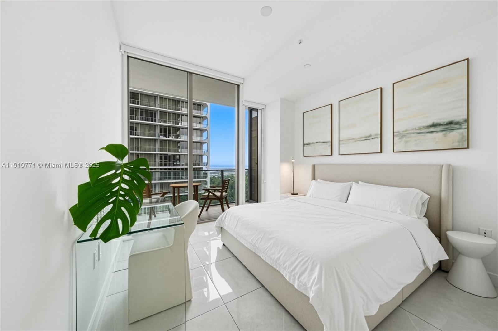 2678 Tigertail Avenue, Unit 1110 Miami, FL 33133 - Photo 28 of 77 a bedroom with a bed a potted plant and a window
