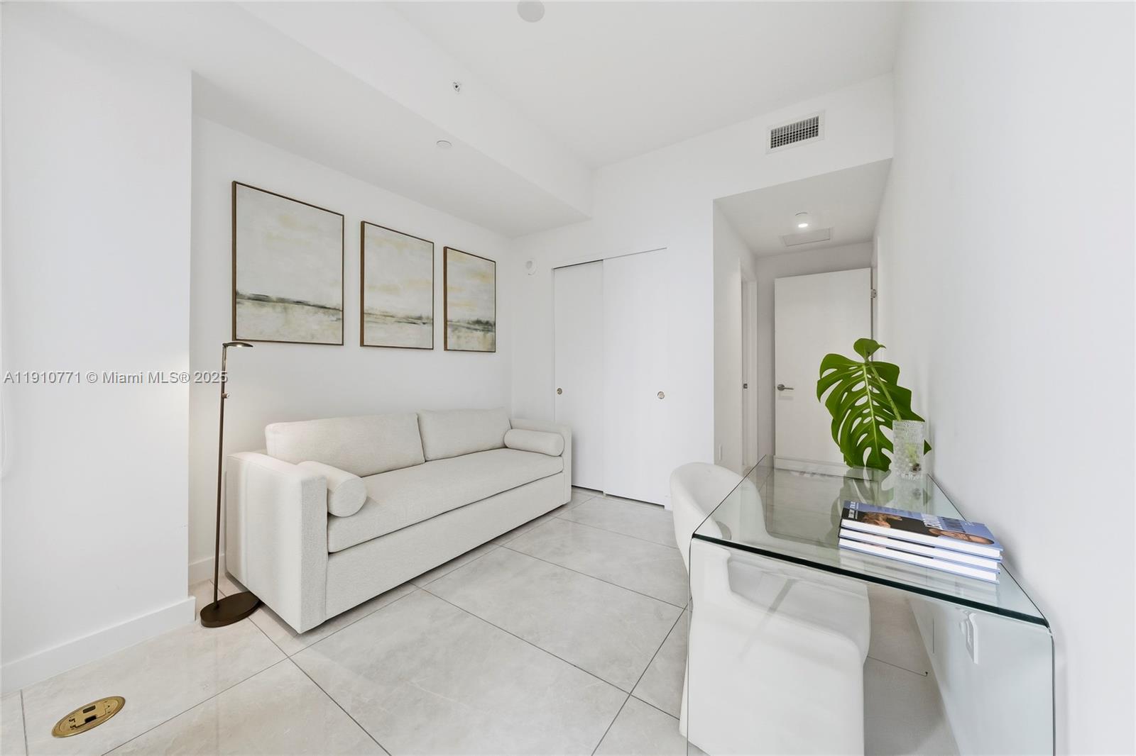 2678 Tigertail Avenue, Unit 1110 Miami, FL 33133 - Photo 32 of 77 a living room with furniture and a potted plant