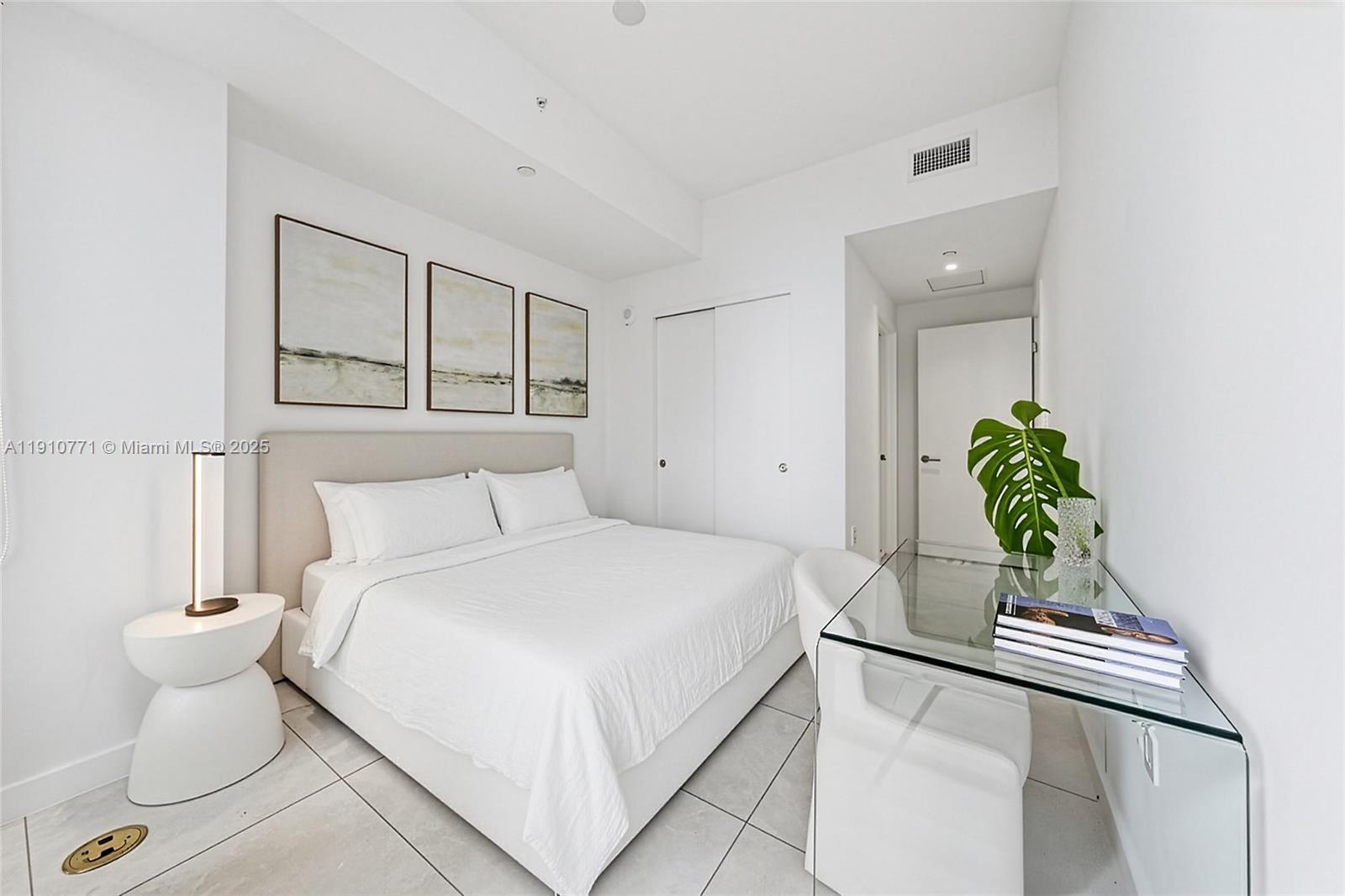 2678 Tigertail Avenue, Unit 1110 Miami, FL 33133 - Photo 33 of 77 a bedroom with a bed and a potted plant