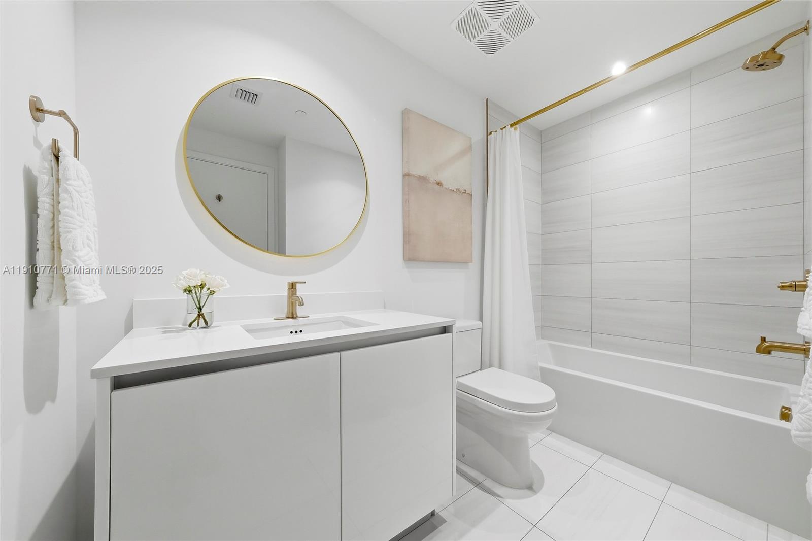 2678 Tigertail Avenue, Unit 1110 Miami, FL 33133 - Photo 35 of 77 a bathroom with a sink a toilet and a mirror