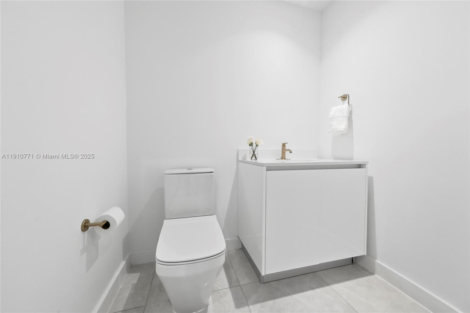 2678 Tigertail Avenue, Unit 1110 Miami, FL 33133 - Photo 38 of 77 a white toilet sitting next to a white sink