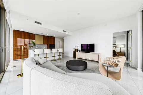 a hallway with furniture and a potted plant